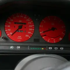 Custom red instrument cluster in a BMW E30 dashboard, speedometer to 300 km/h and 7,500 RPM tachometer