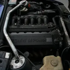 BMW M Power S50B30 engine swapped into a BMW E30 engine bay with a strut brace